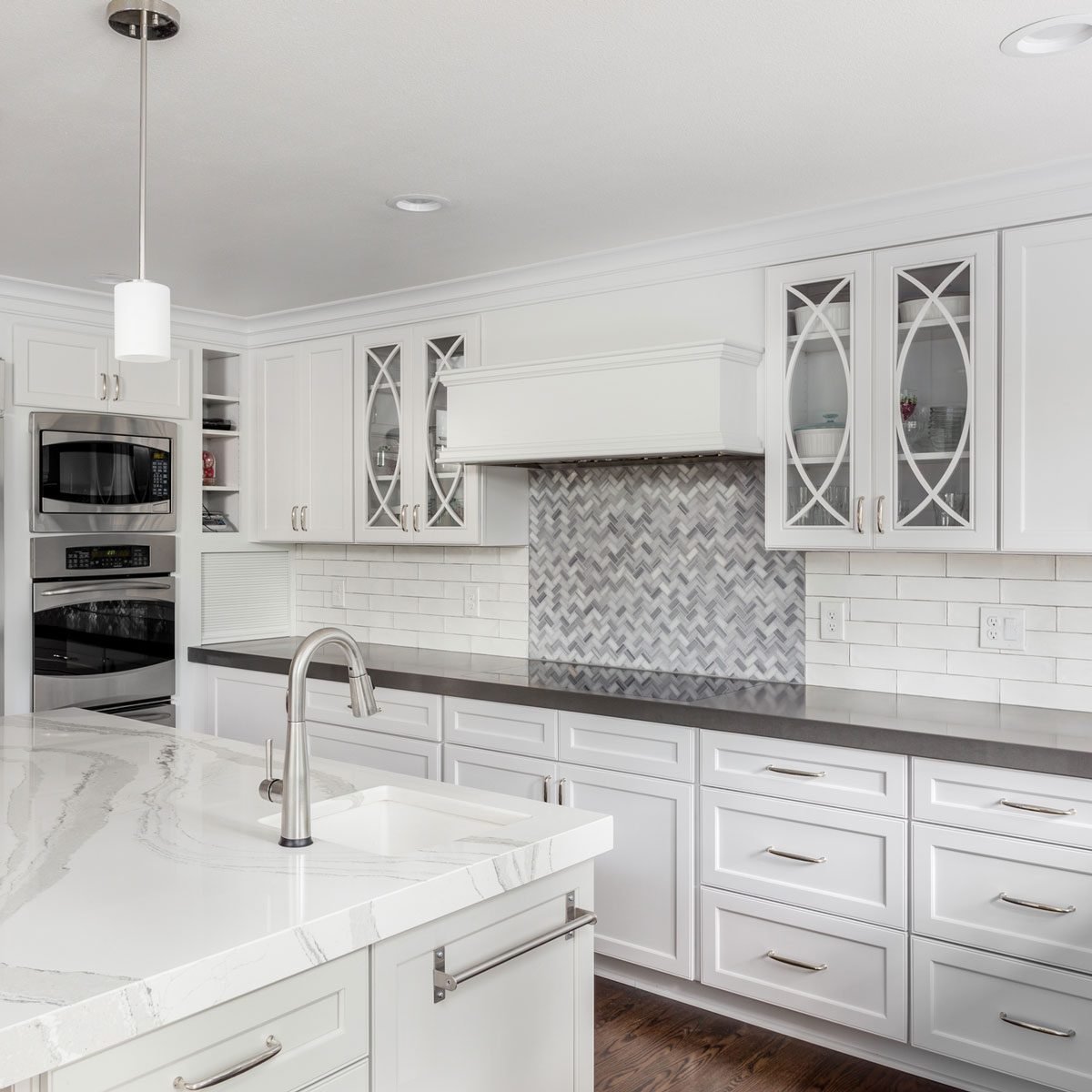 Kitchen with two tile backsplashes