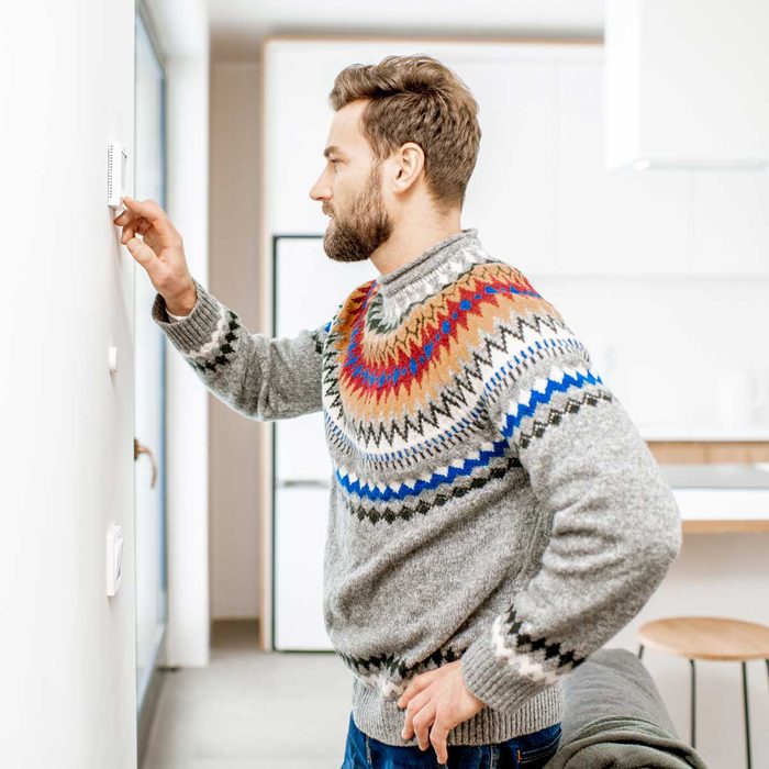 Man adjusting the thermostat