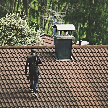 Chimney sweep on a roof