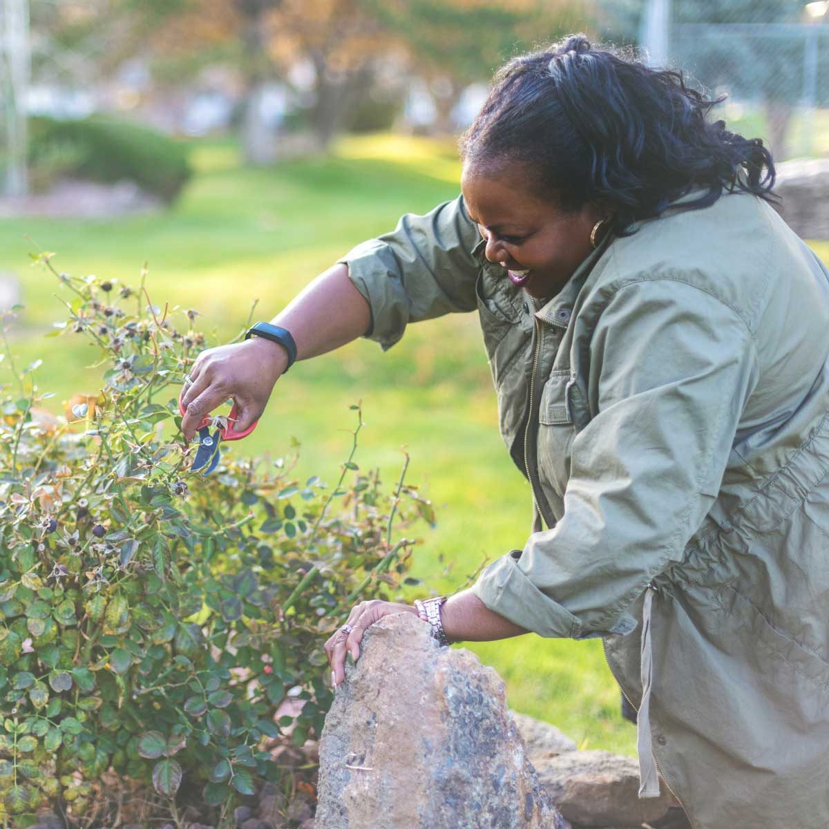 Woman trimming garden in the fall