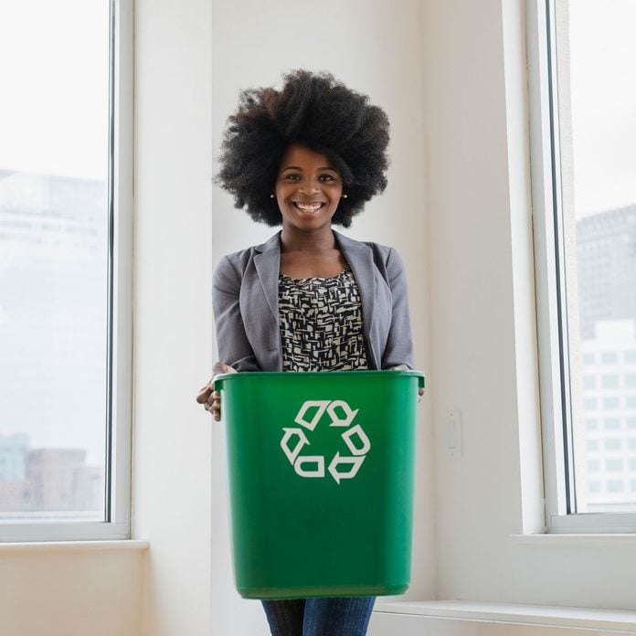 Woman holding a recycling bin