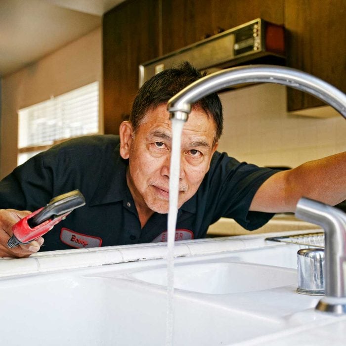Pro plumber fixing sink