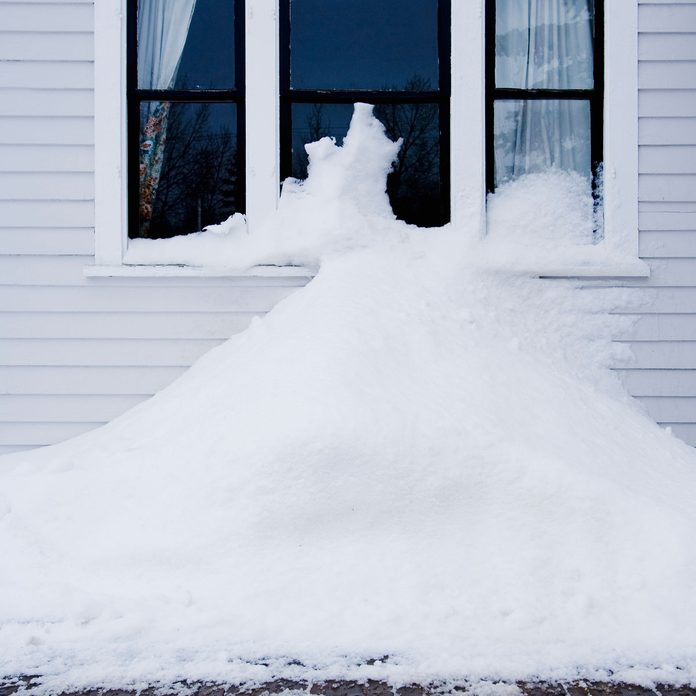 Snow piled against a house
