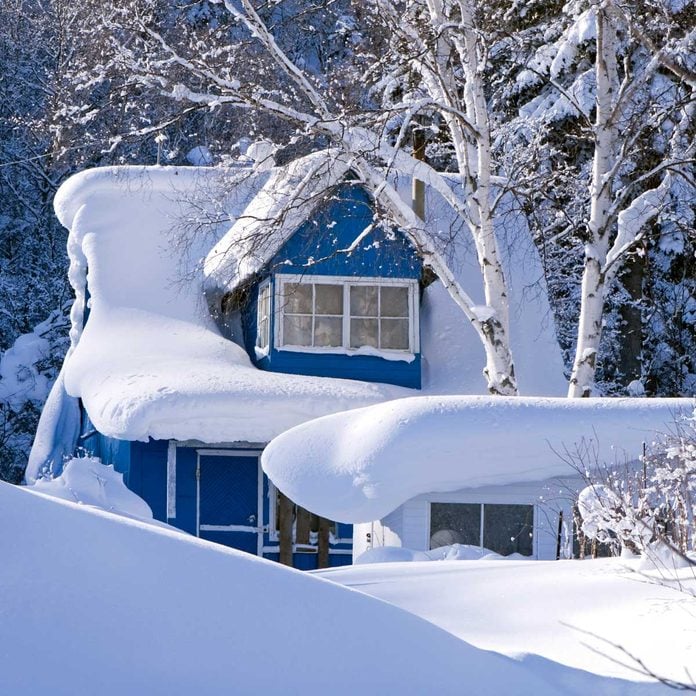 House with a large amount of snow on its roof
