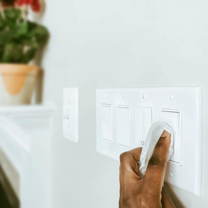 Cleans Light Switches Using Disinfectant Wipe Gettyimages 1211886751