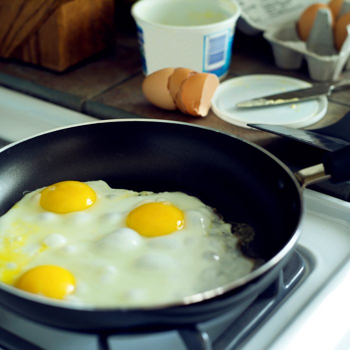 Non-stick frying pan with sunny side up eggs Gettyimages 522900182