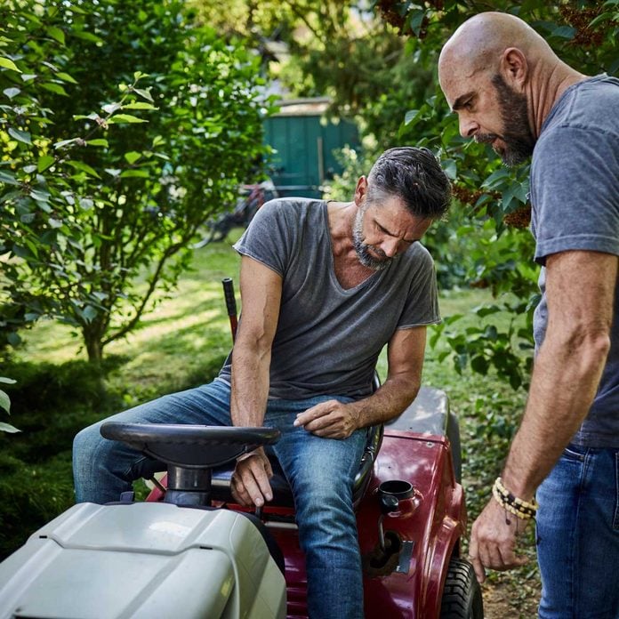 Men Fixing Lawn Tractor Gettyimages 1071680788