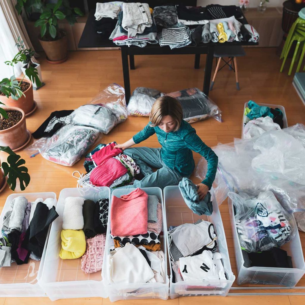 Woman Organizing Clothes Gettyimages 1221702981