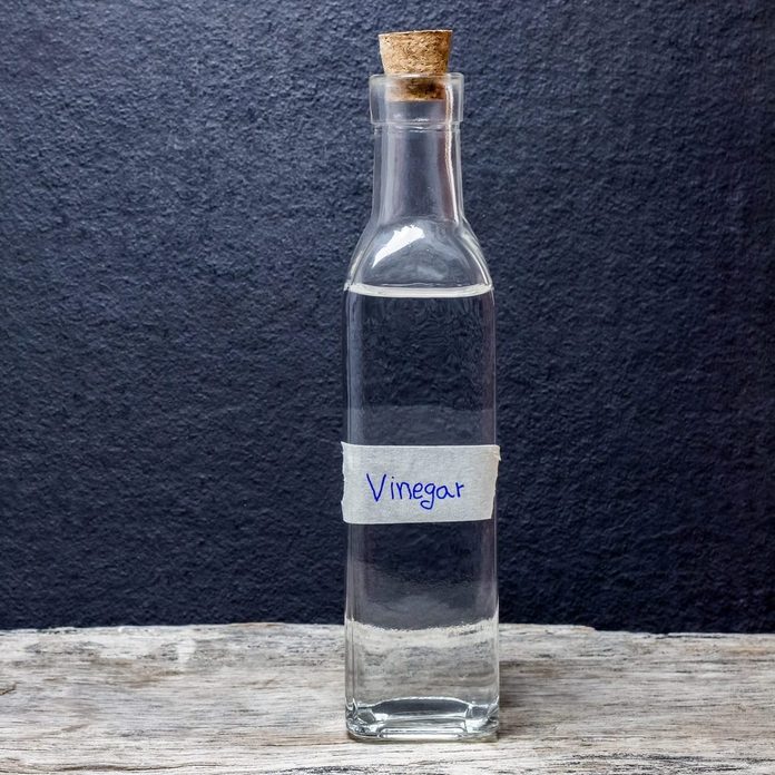 white vinegar on the wooden table