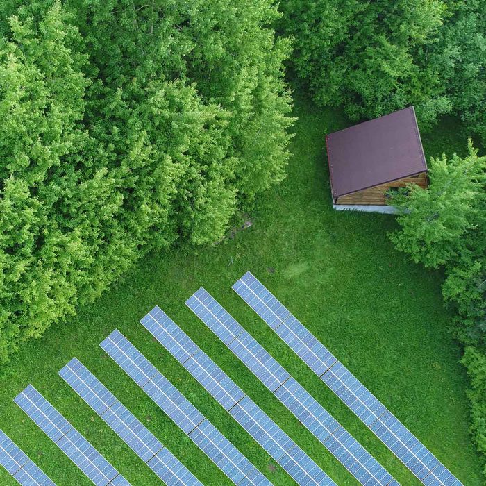 Cabin Field With Solar Panels Gettyimages 1299971943