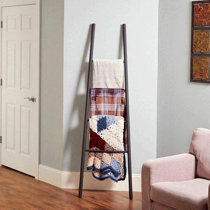 Blanket Ladder made from dowels leaning against a living room wall