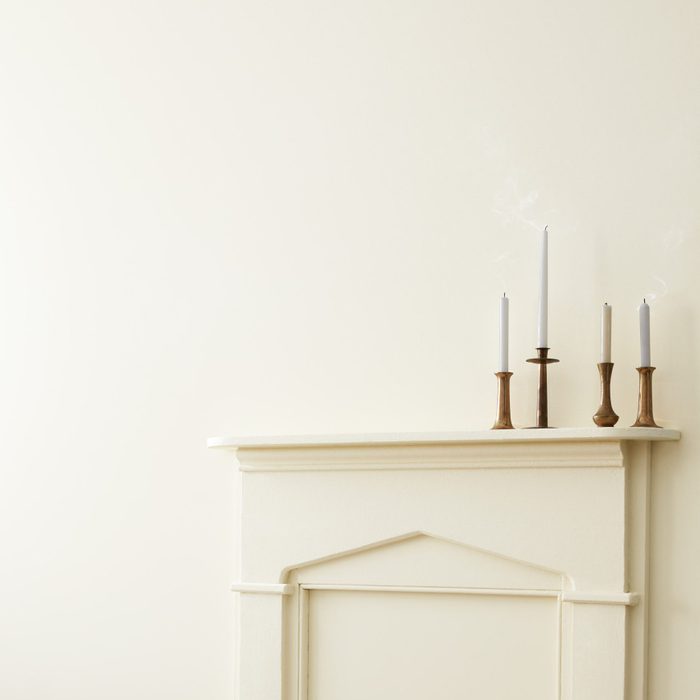 White Painted walls with candle sticks on a matching fireplace mantle
