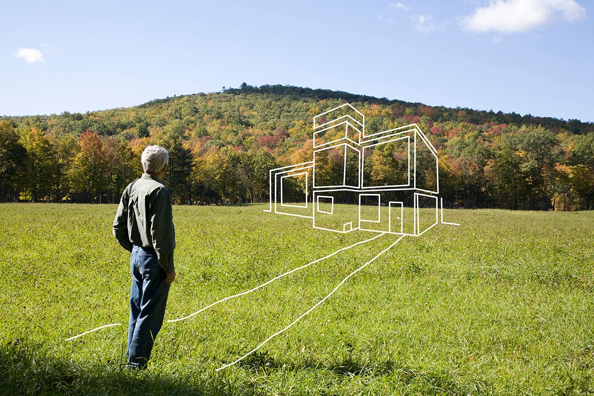 Man Standing In Field Admiring Imaginary House