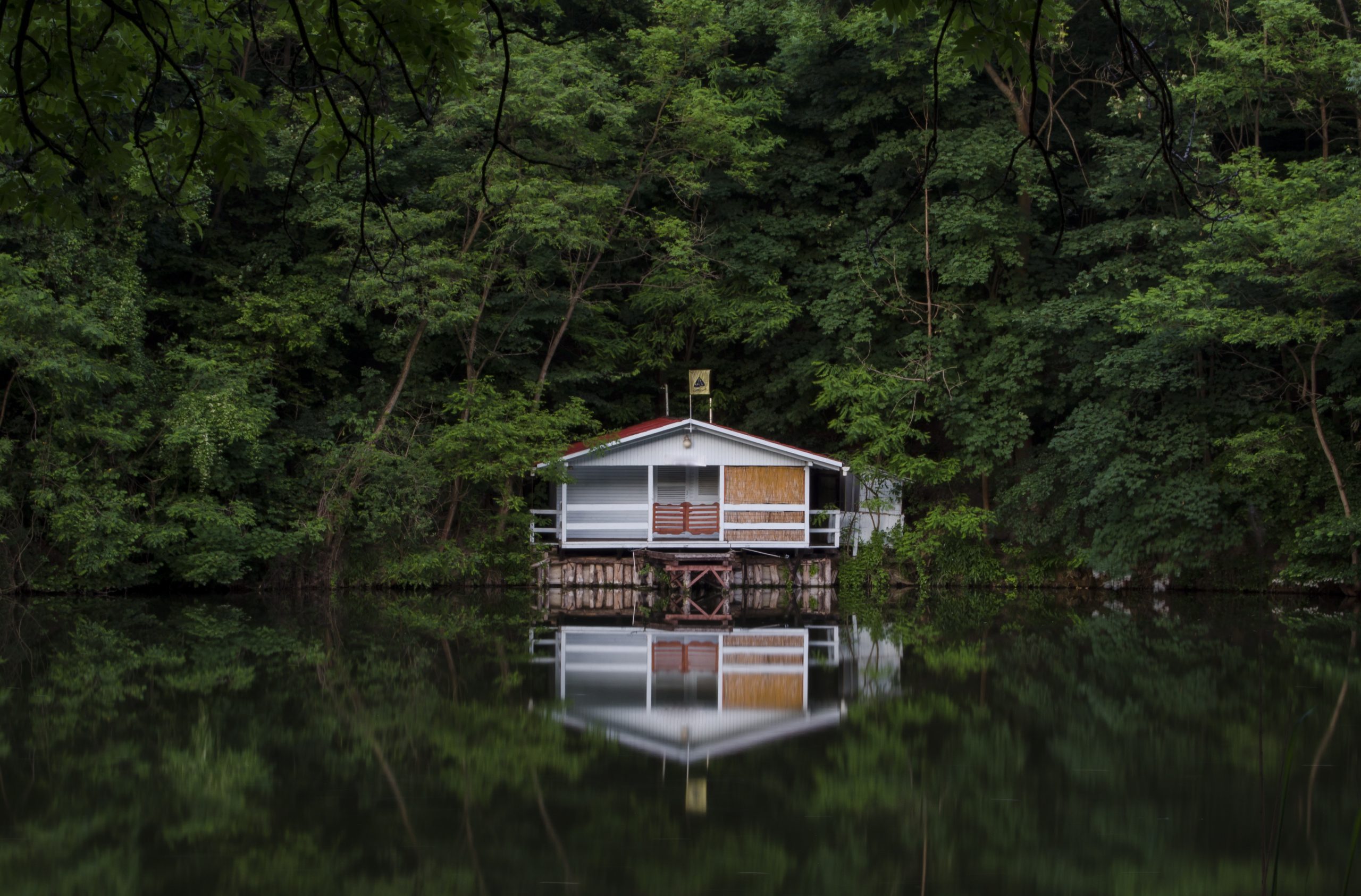 Cabin On Lake In Middle Of Forest