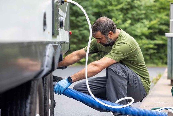 A man emptying his RV greywater tank.