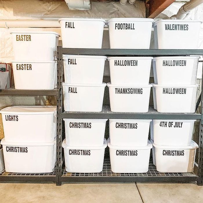 functional basement shelving with white bins for storage