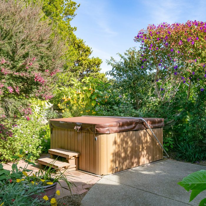 hot tub with cover closed in backyard