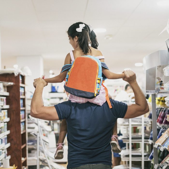 Father and daughter buying school supplies preparing to go back to school, on shoulders