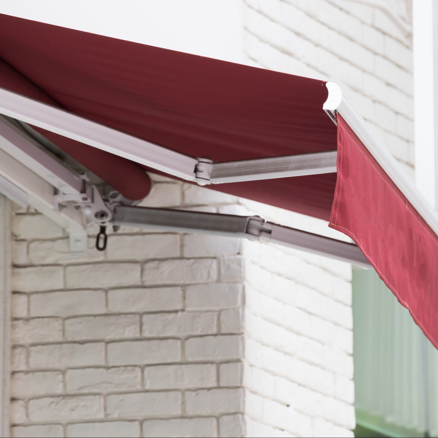 red manual roll out patio awning