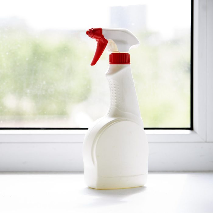 cleaning spray bottle on windowsil