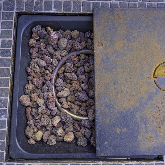 Table Fire Pit with rocks on outside deck patio at home