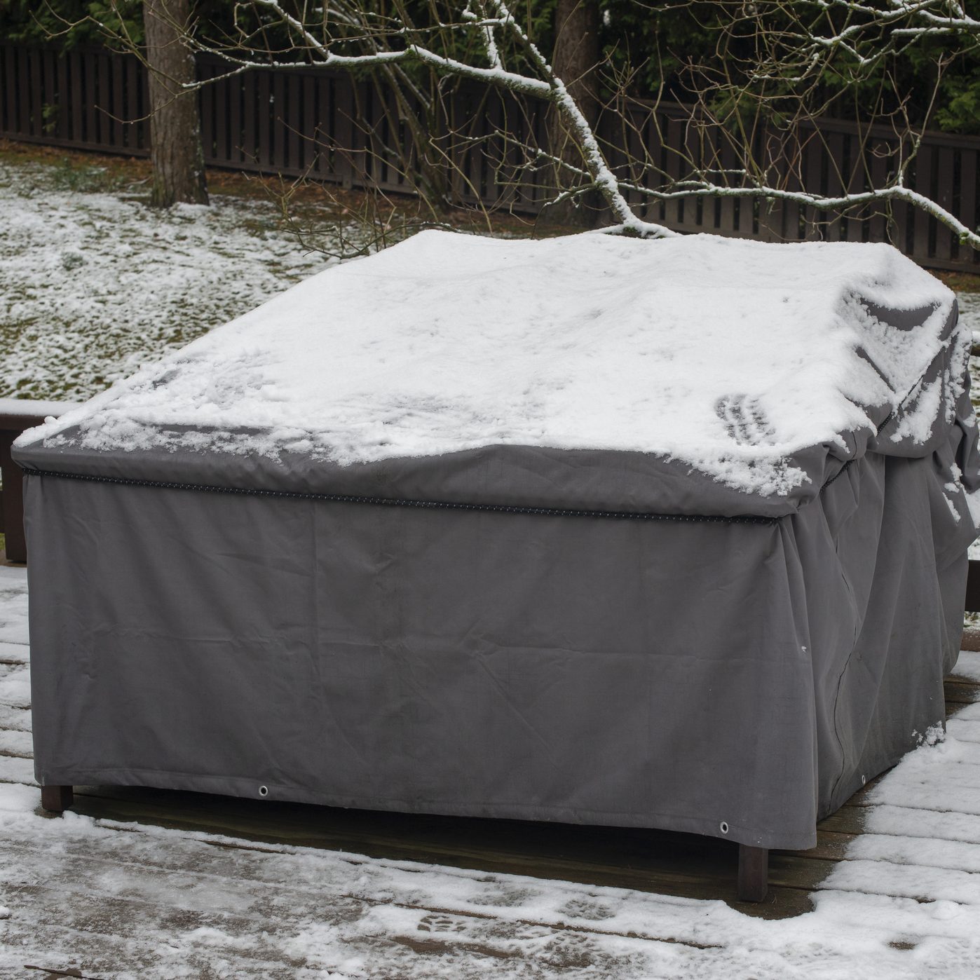 Patio furniture Cover protecting outdoor furniture from snow, close up.
