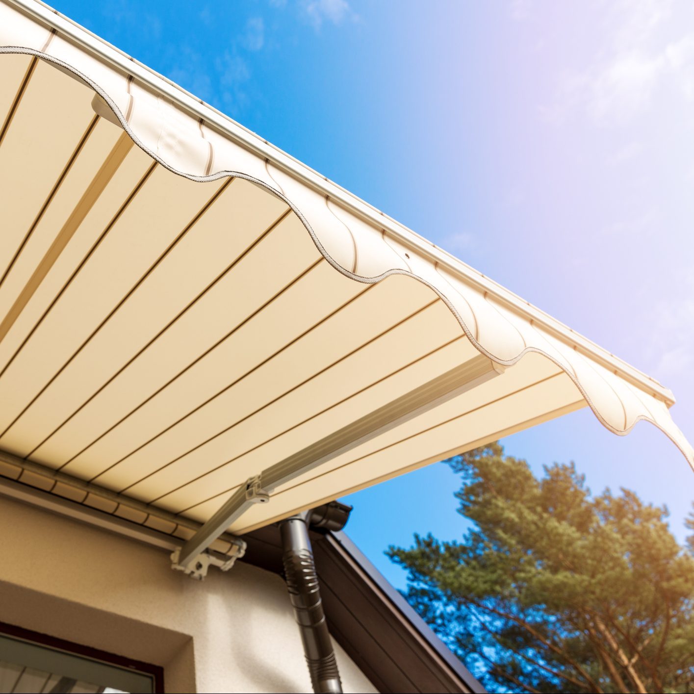 awning over balcony window against blue sky