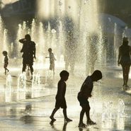 people try to stay cool by playing in fountains during a heat wave