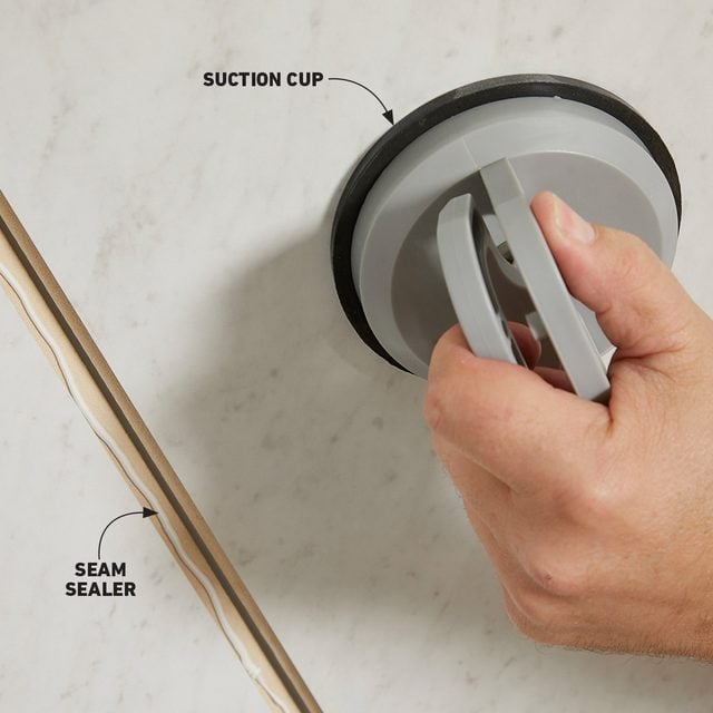 Using a tile setting suction cup to set panels