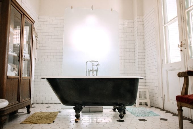 free standing clawfoot tub in large bathroom