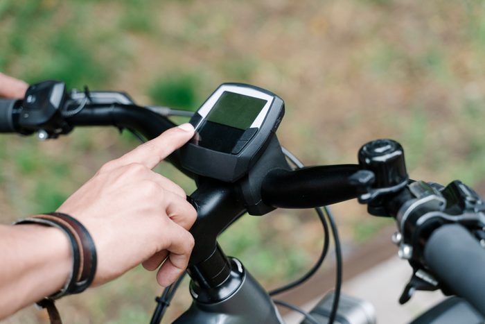 man using GPS device attached to bicycle