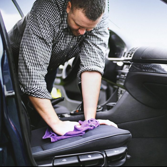 man getting water stain out of seat of car