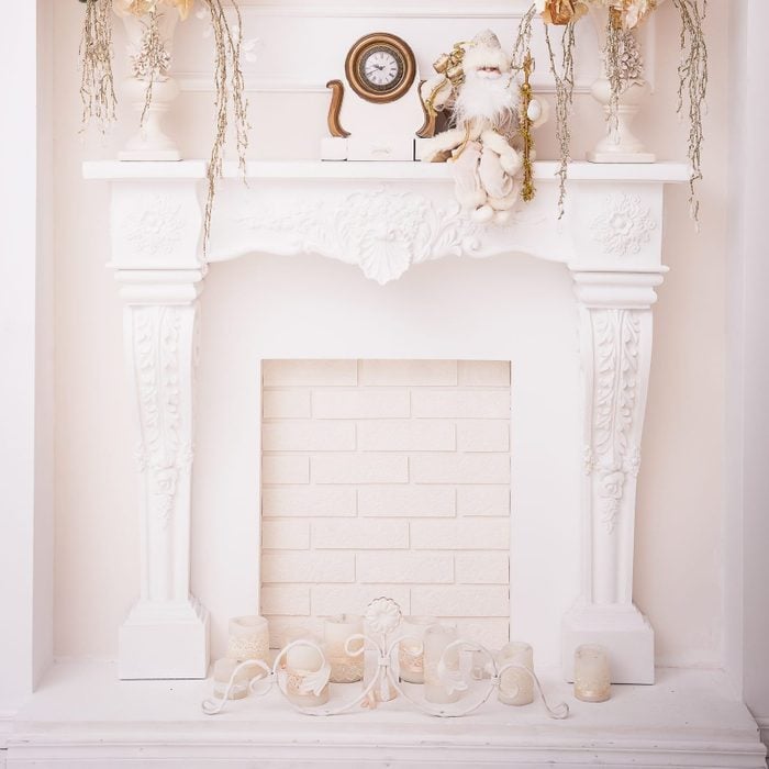 white fireplace in classical arch .