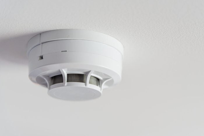 Close up of a smoke detector on a ceiling in a home