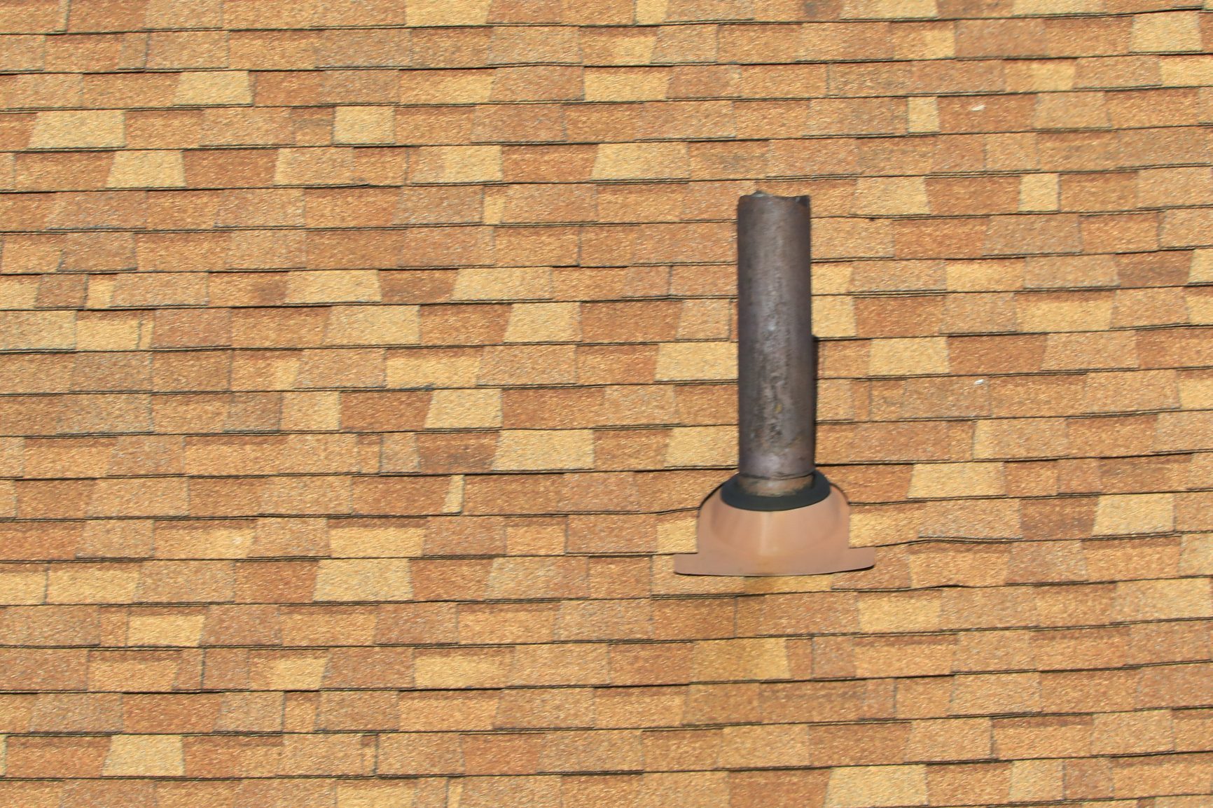 Vent stack for bathroom plumbing gasses and odors on a residential roof