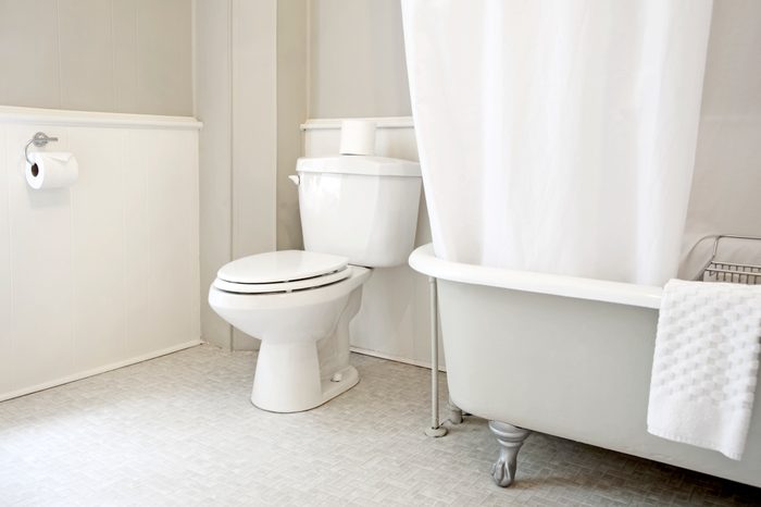 Bathroom interior with toilet and bath tub