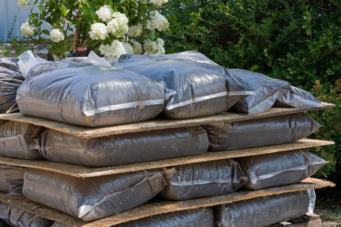 Peat Potting Soil in Plastic Bags stacked outdoors
