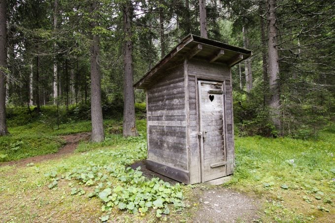 Wooden outhouse at a cabin in the woods