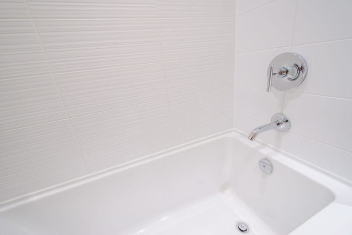 standard white bathtub in bathroom