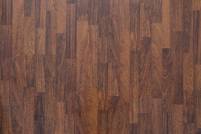 Brown wood laminate flooring texture background in house.