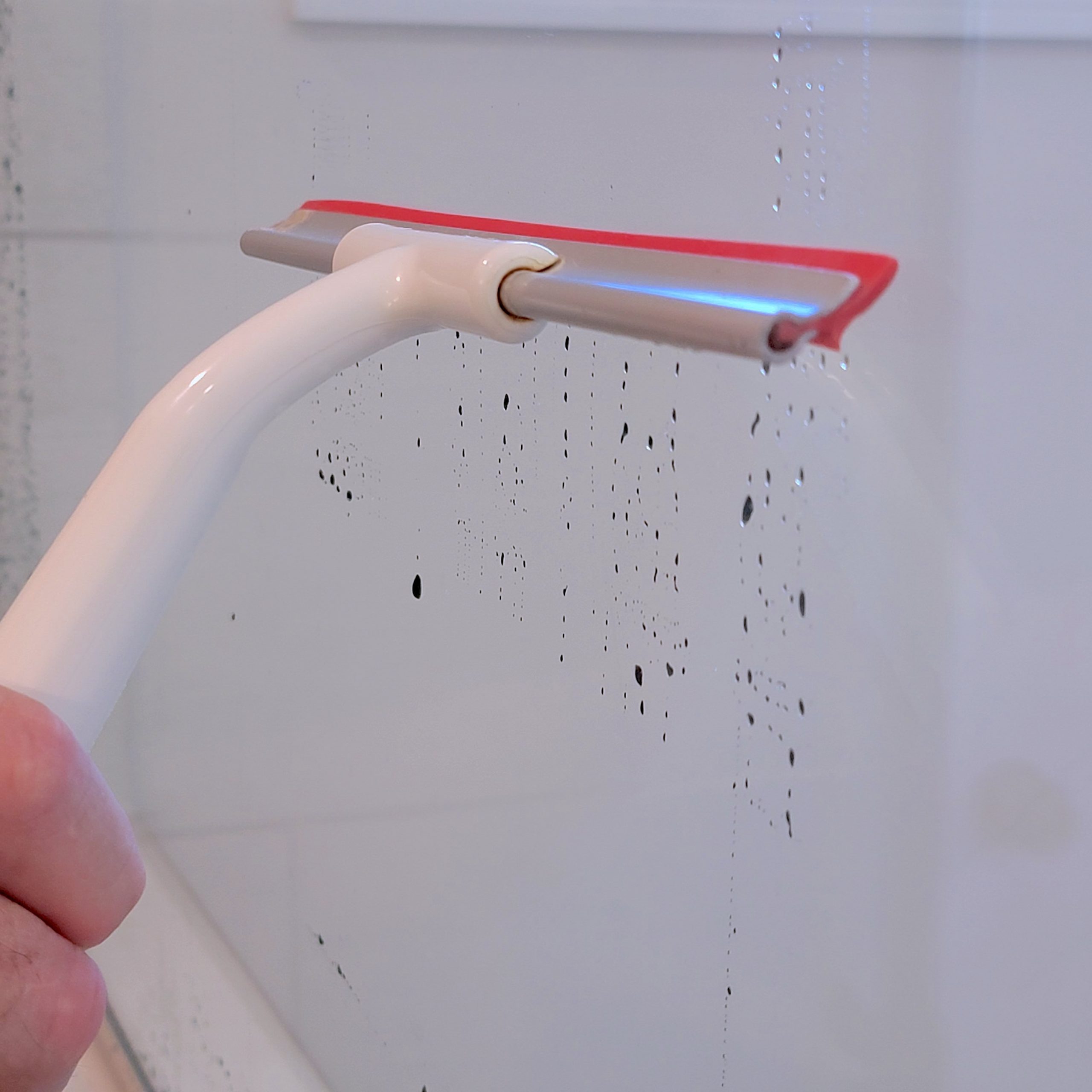 Shower Cleaning Squeegee being used on the shower glass