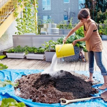 woman mixing amendments into garden soil