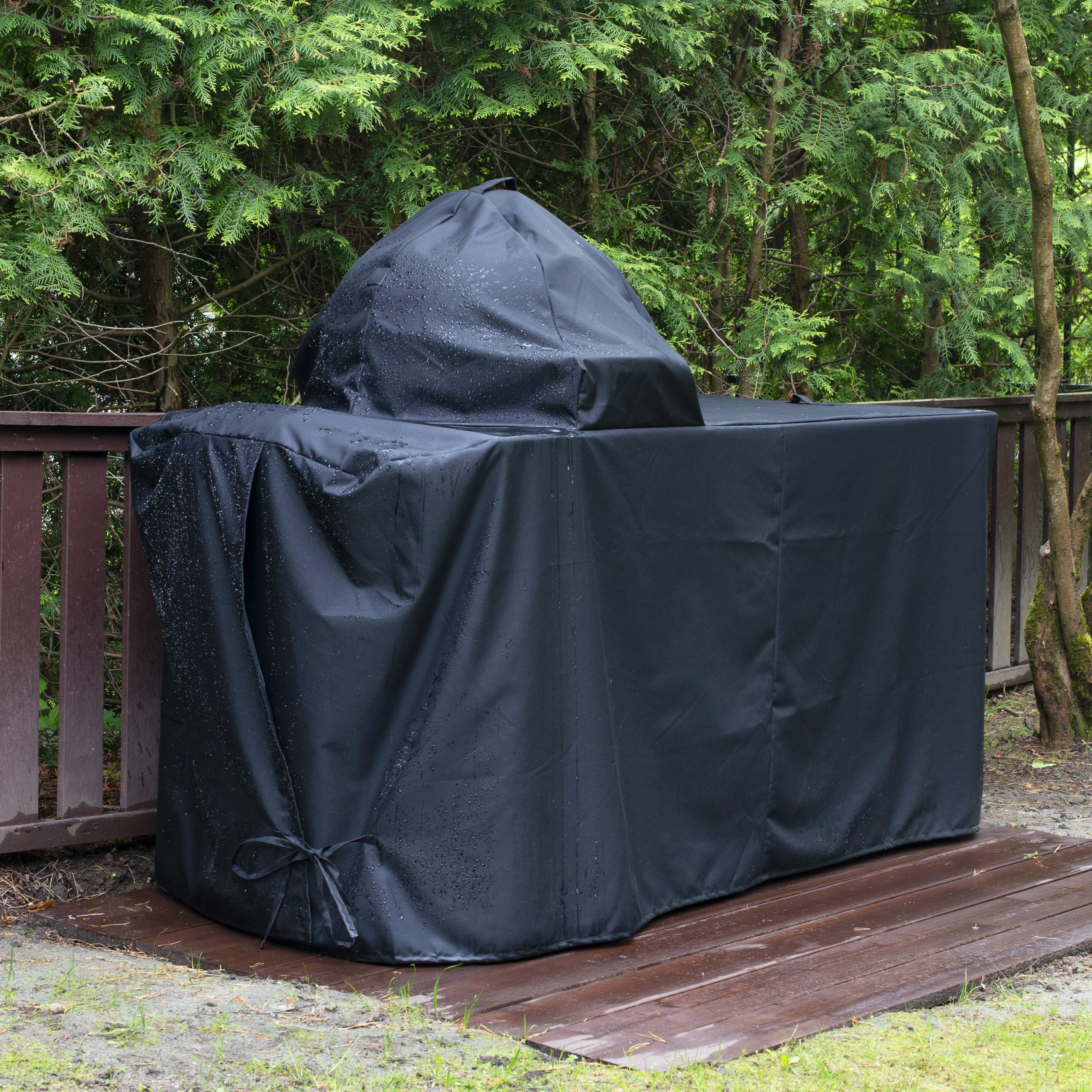 Barbecue Grill Cover Protecting Kamado Style Ceramic Grill From Rain.