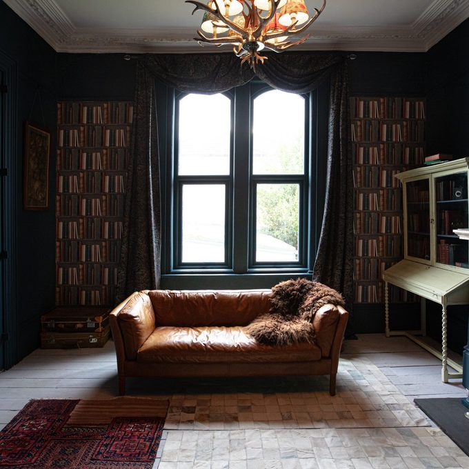 moody living room with dark blue walls