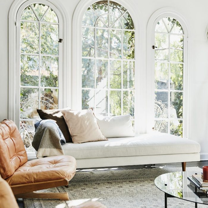 living room with white walls and arched windows