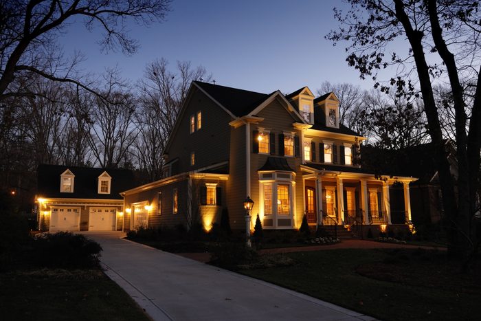 residential house with lights on at dusk