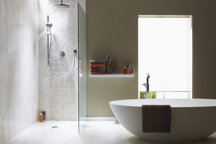 Interior of bathroom with walk in shower and freestanding bath tub
