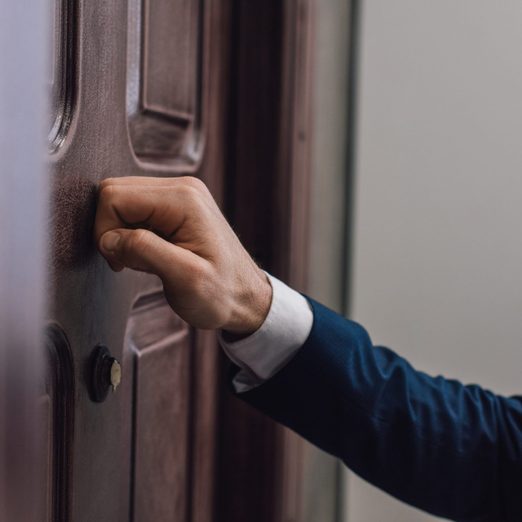 Cropped View Of Collector Knocking On Door With Hand