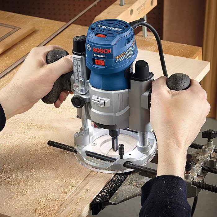 hands using a Bosch Variable Speed Palm Router