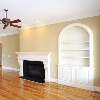 unfurnished living room featuring crown molding